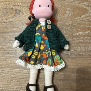 Charming Doll with Dark Green Sweater and Floral Dress